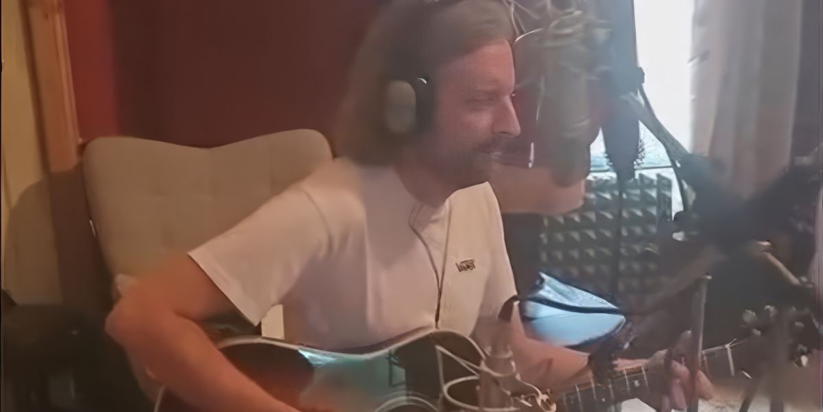 Conor Foley playing guitar and singing