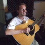 David Rynhart playing acoustic guitar
