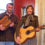 Dave and his accordion and Lonneke holding an acoustic guitar